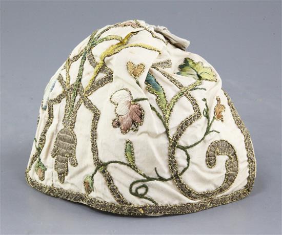 An early 18th century embroidered silk and metal thread cap,